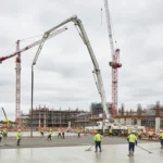 Concrete boom pump pouring a house slab on a residential construction site in Canberra with professional crew