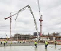 Concrete boom pump pouring a house slab on a residential construction site in Canberra with professional crew